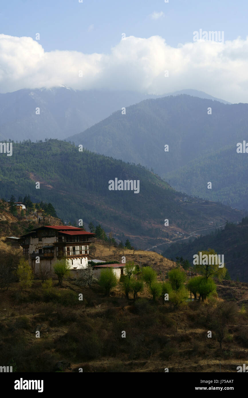 Farm and farmhouse along Highway south of Thimphu, Bhutan Stock Photo