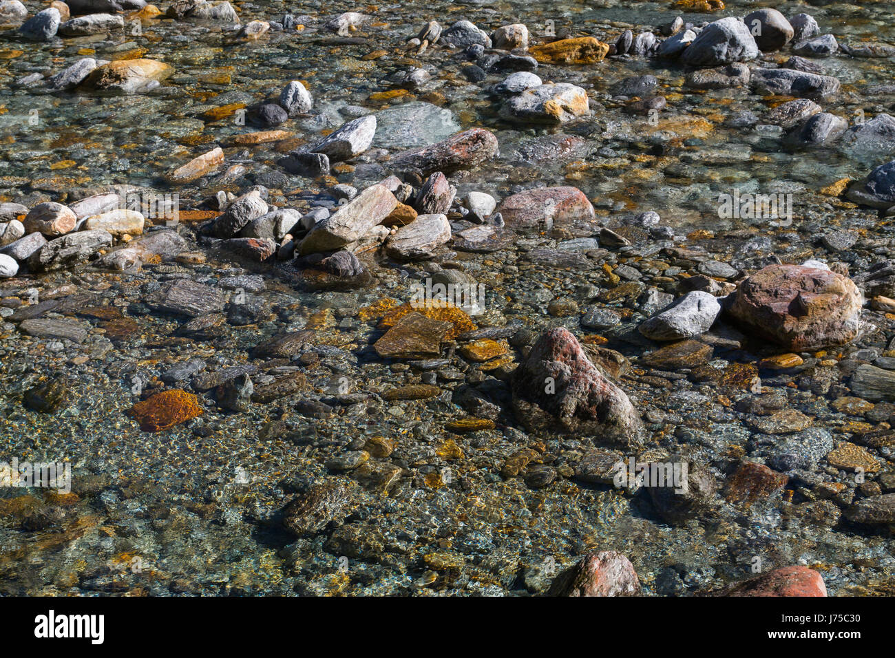 crystal clear water and colorful stones of natural wild river verzasca in switzerland Stock Photo