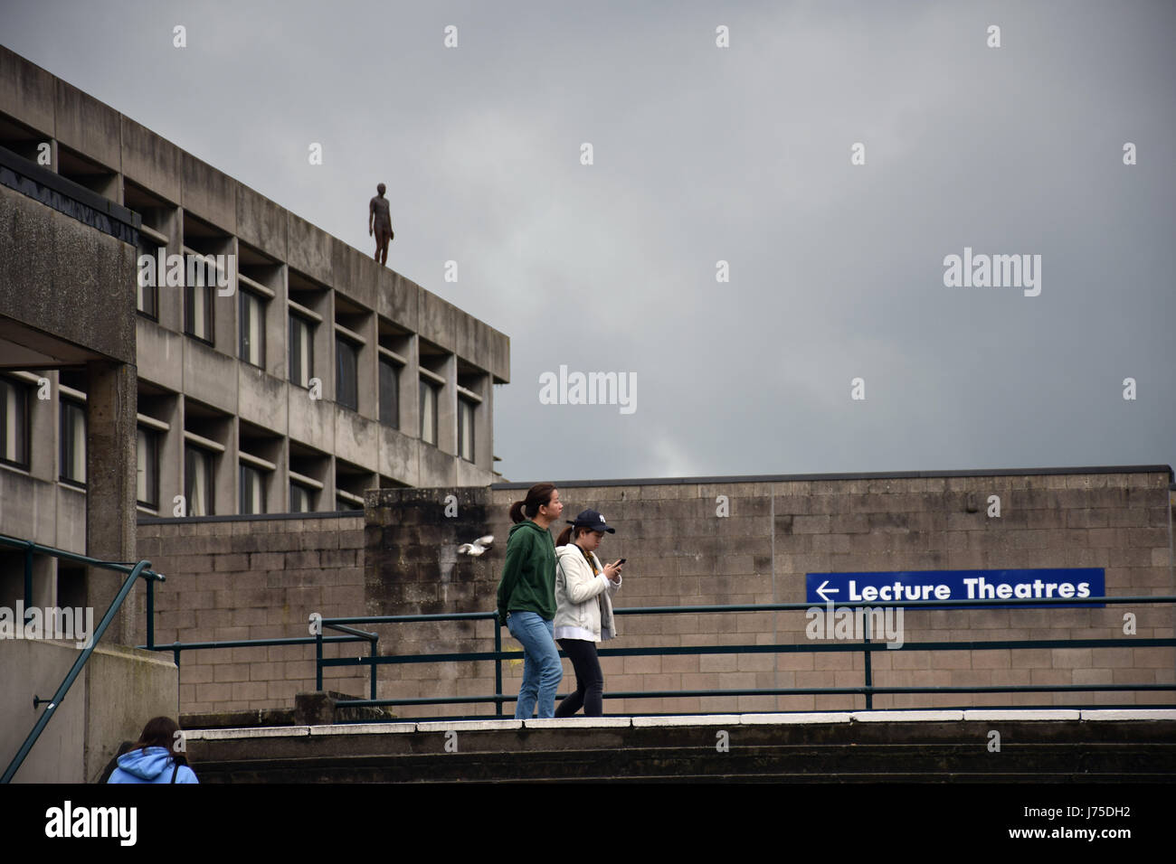 Newly installed Antony Gormley statue on top of the University of East