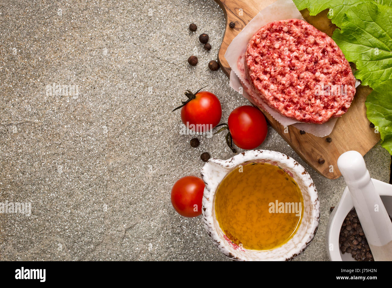 Raw beef meat steak cutlets on stone Stock Photo