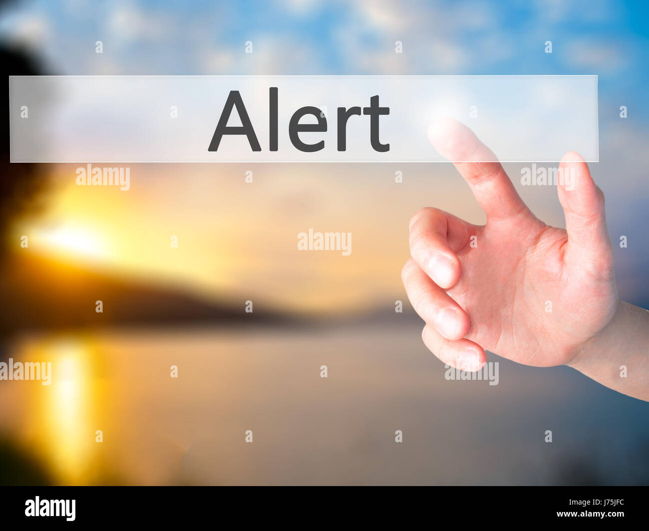 Alert - Hand pressing a button on blurred background concept . Business ...