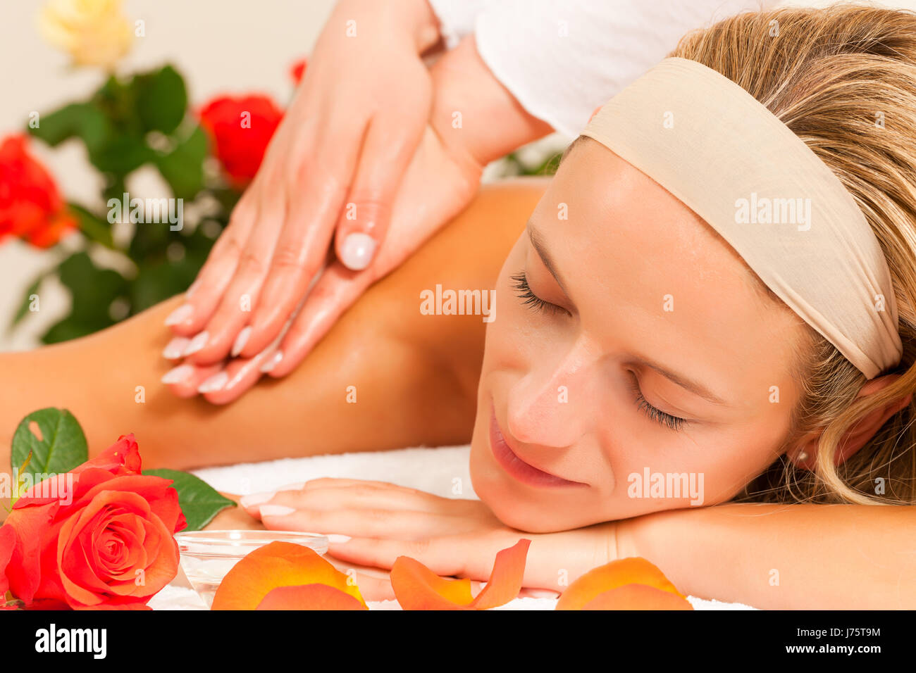 woman back massage to give a jerk masseuse spa wellness woman humans human Stock Photo
