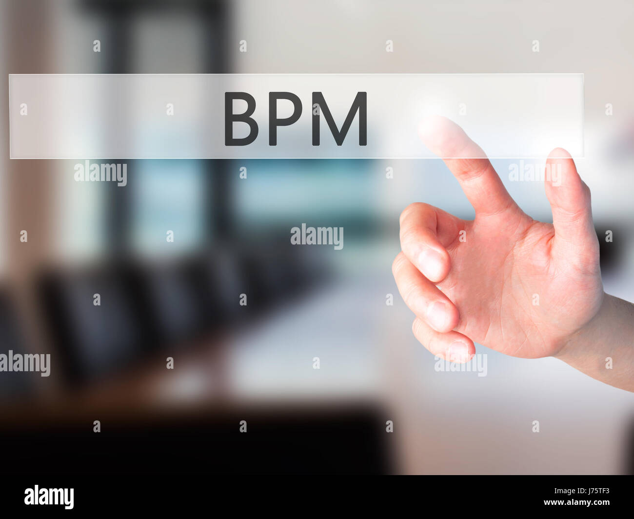 BPM (Business Process Management) - Hand pressing a button on blurred ...