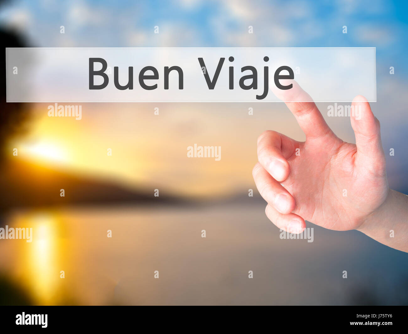 Buen Viaje (Good Trip in Spanish) - Hand pressing a button on blurred background concept . Business, technology, internet concept. Stock Photo Stock Photo