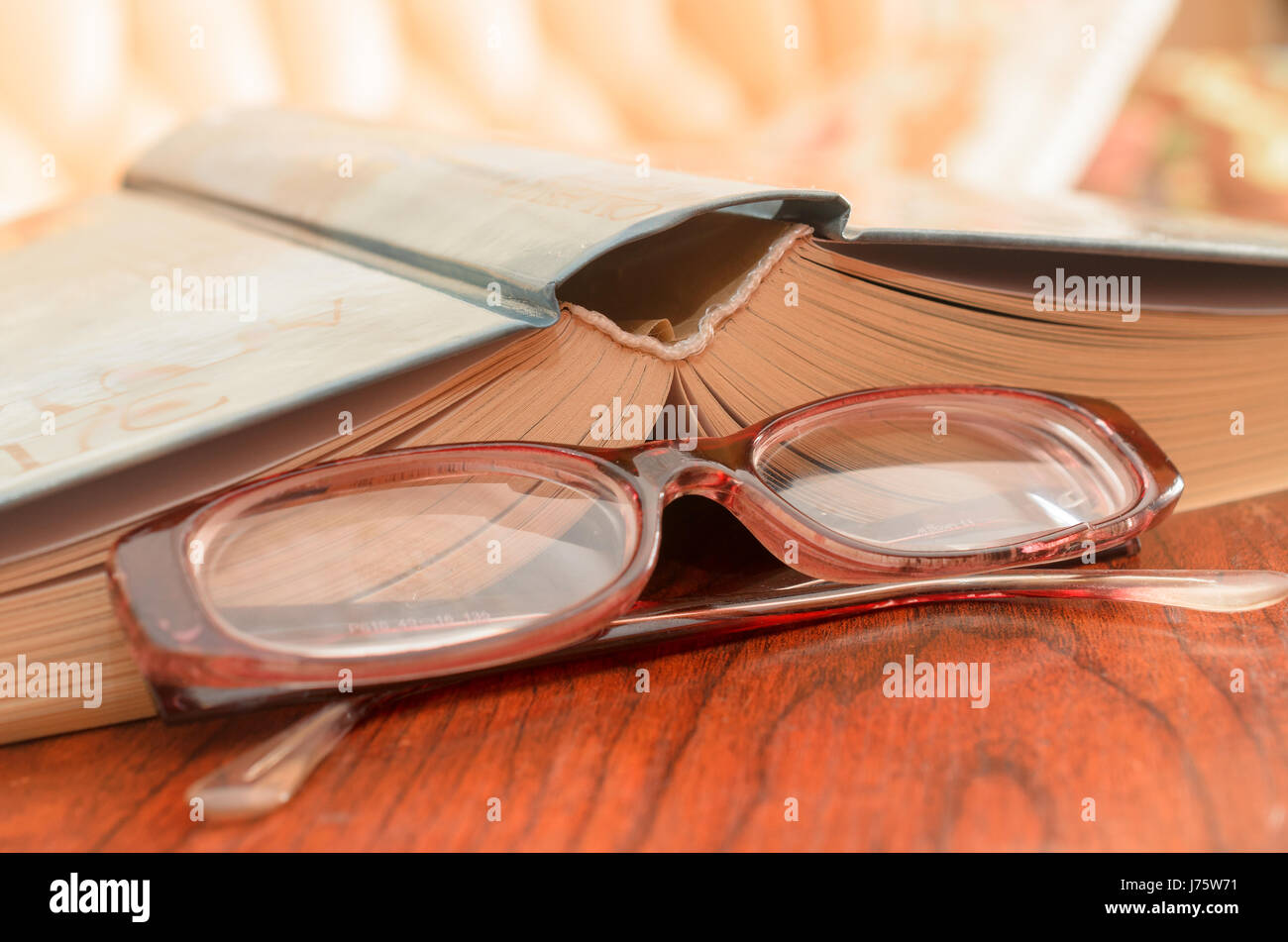 Lying on the table an open book and a number of glasses Stock Photo - Alamy