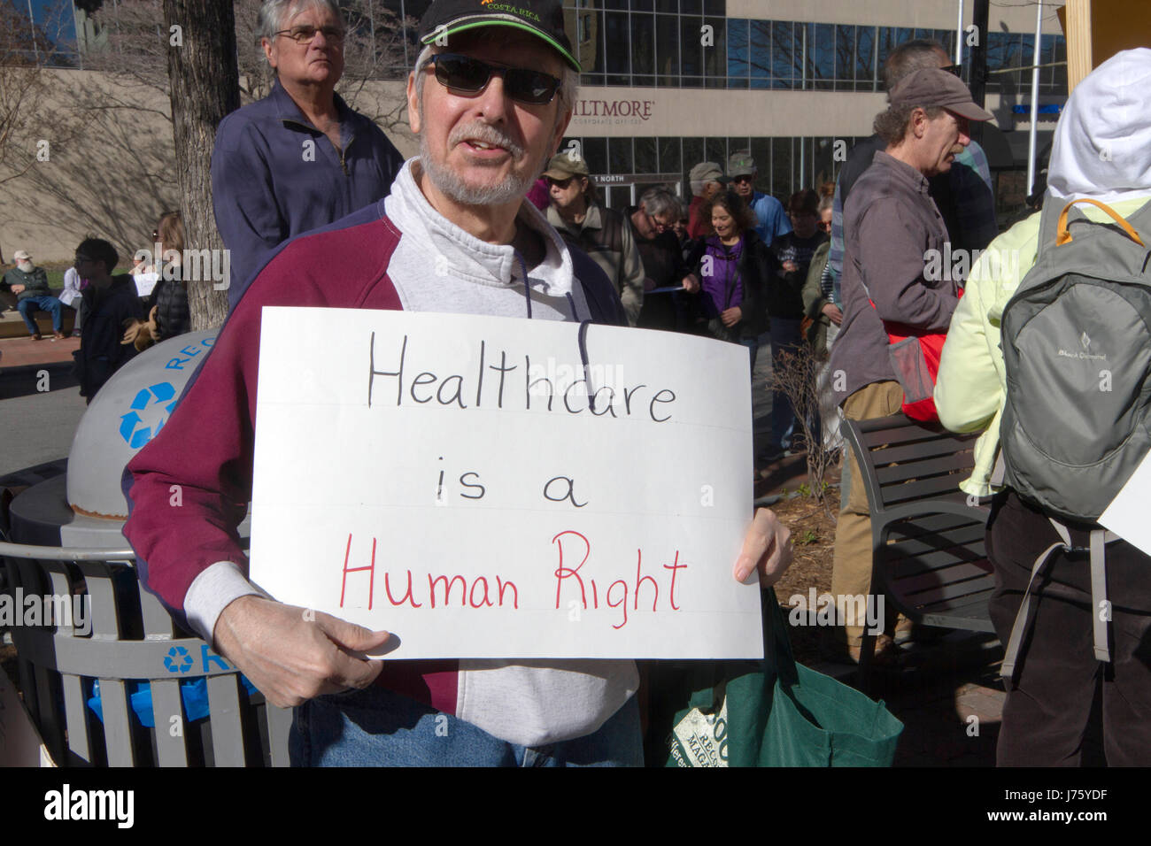 Asheville, North Carolina, USA - February 25, 2017:  A man hold a sign at a crowded Affordable Care Act rally saying 'Healthcare is a Human Right' as  Stock Photo