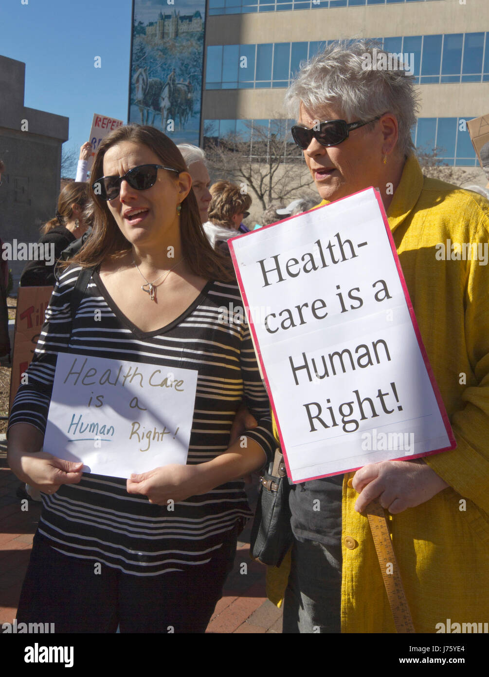 Asheville, North Carolina, USA - February 25, 2017:  Women hold signs at an Affordable Care Act rally saying 'Healthcare is a Human Right' as Republic Stock Photo