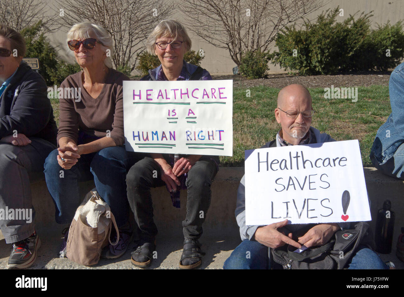 Asheville, North Carolina, USA - February 25, 2017:  Older Americans hold signs at an Affordable Care Act rally saying 'Healthcare is a Human Right' a Stock Photo