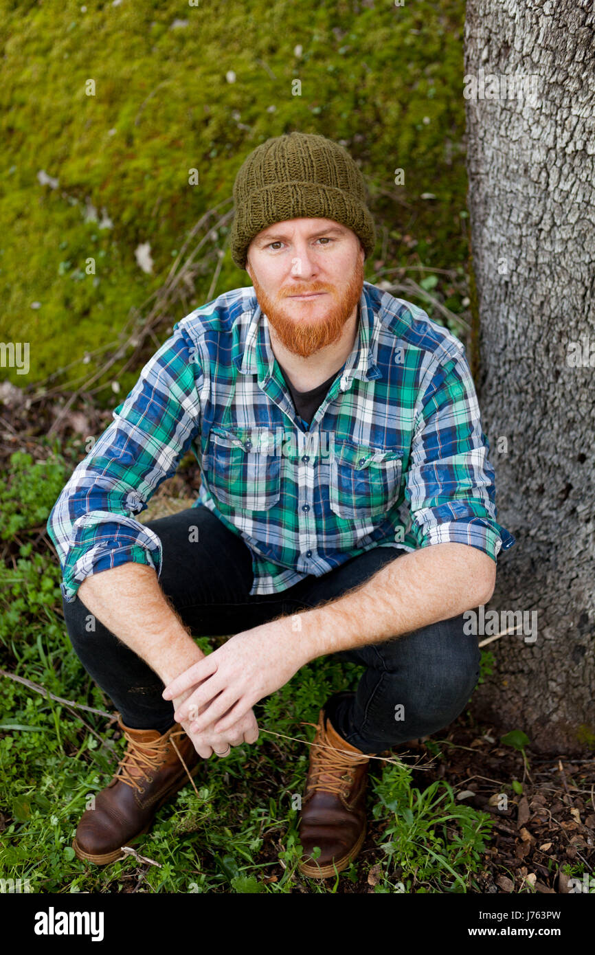 Portrait of a red haired man thinking in th forest Stock Photo