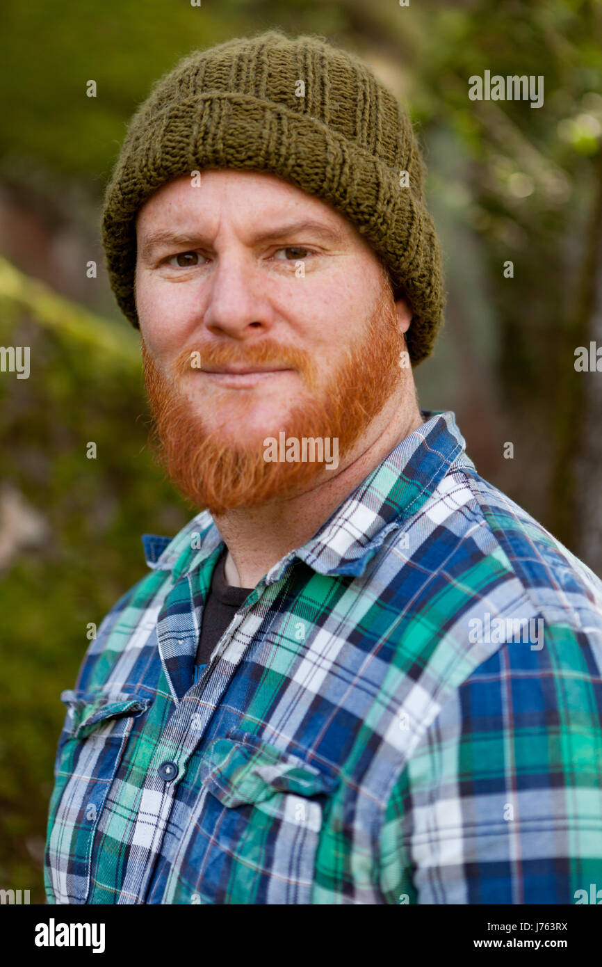 Portrait of a red haired man thinking in th forest Stock Photo