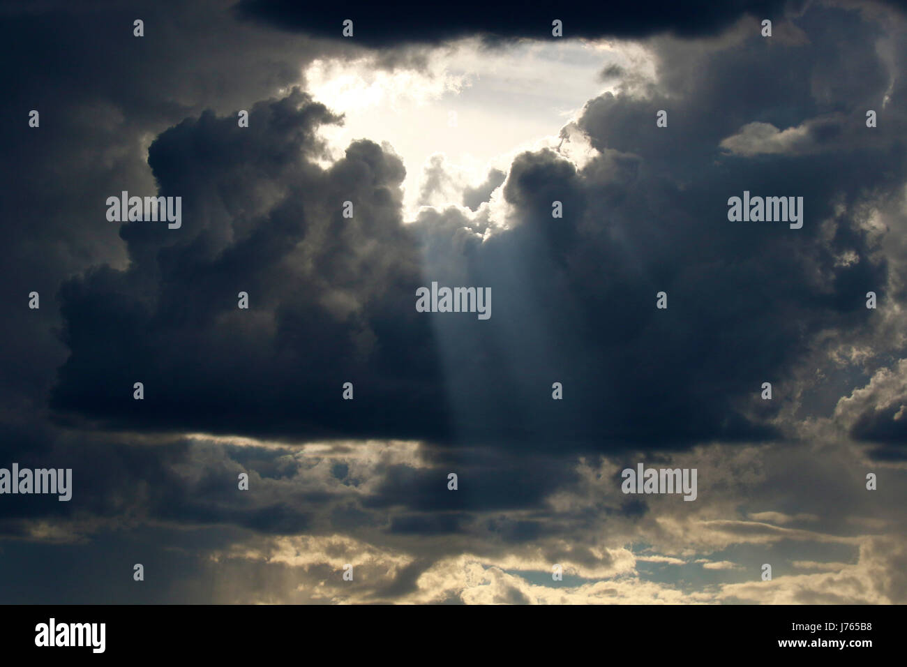 Dramatic dark skies cloud formation with a hole in the middle where the ...