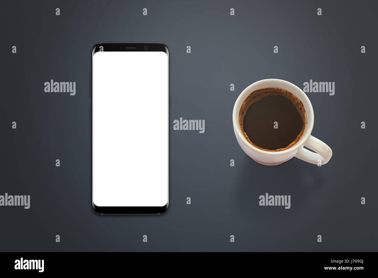 Modern smart phone mockup. Top view of desk with phone and cup of