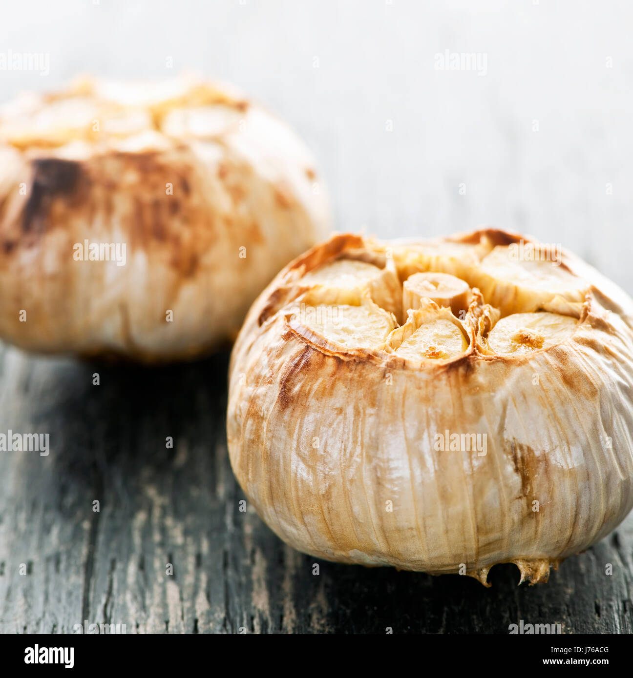 closeup boil cooks boiling cooking garlic cloves roasted parched bulbs ...