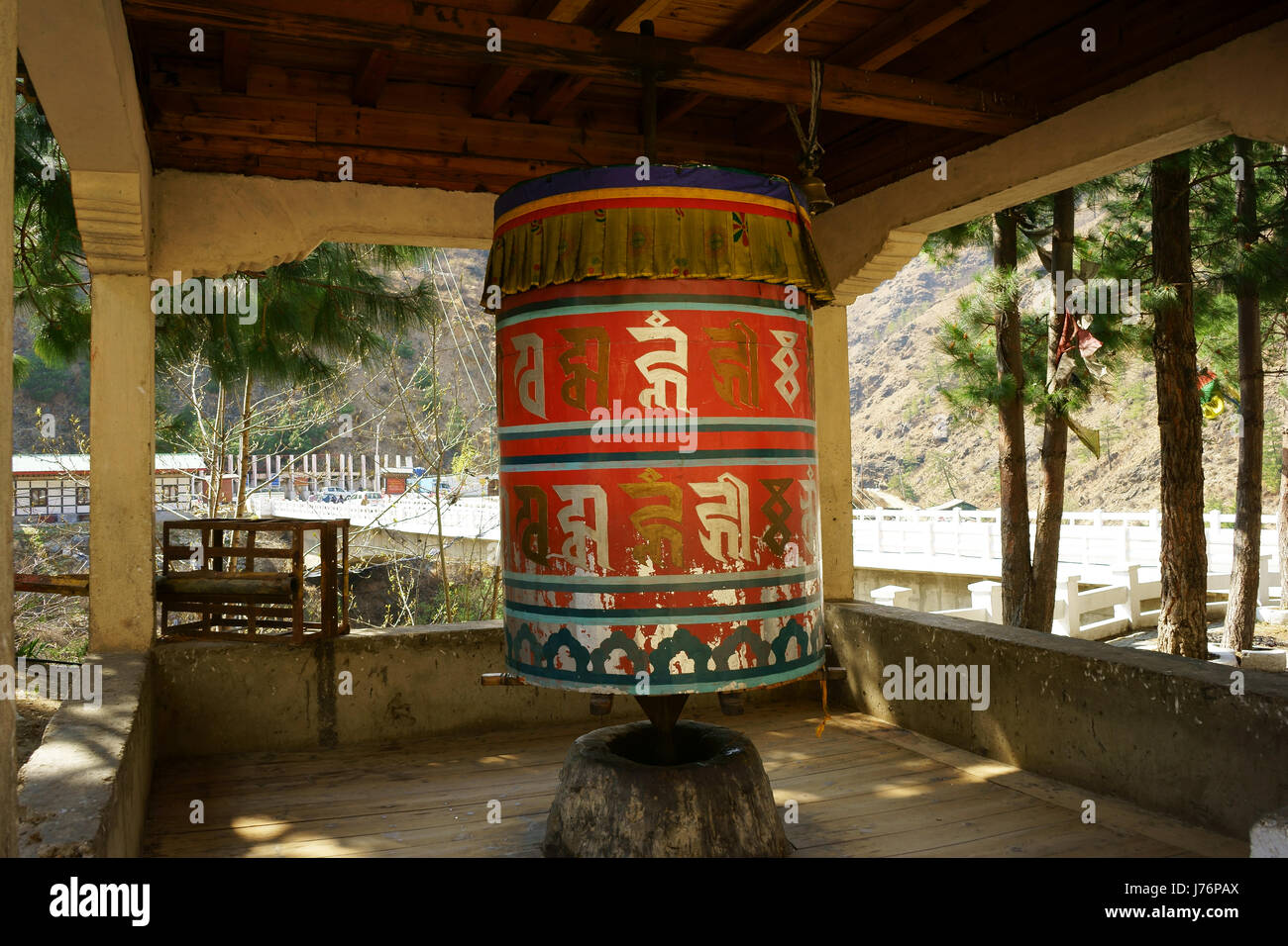 Large prayer wheel at road intersection Paro and Thimphu. Bhutan Stock Photo