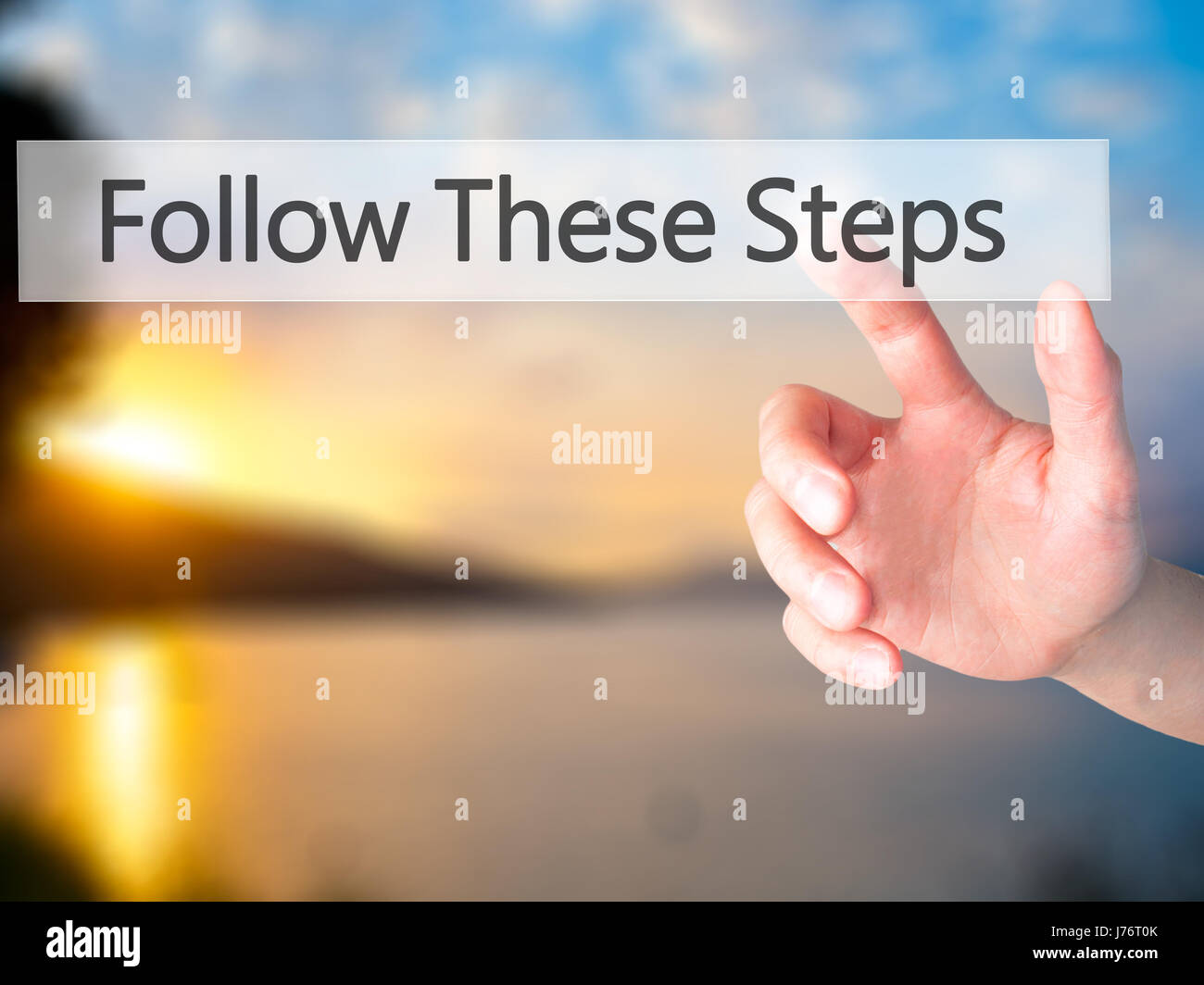 Follow These Steps - Hand pressing a button on blurred background ...