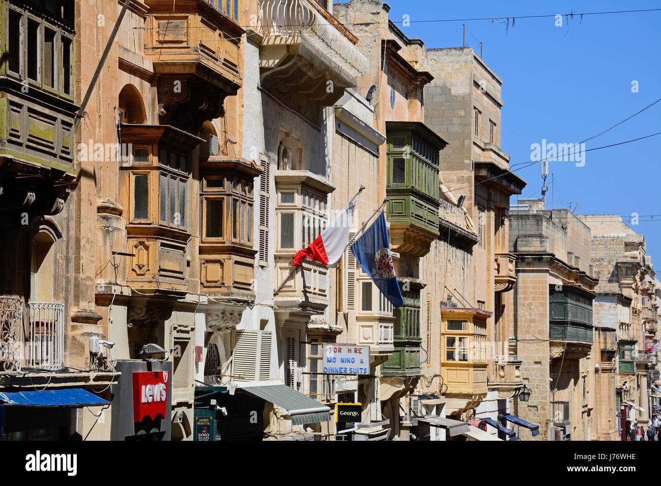Elaborate buildings and shops along Republic Street aka Triq Ir Repubblika, Valletta, Malta, Europe. Stock Photo