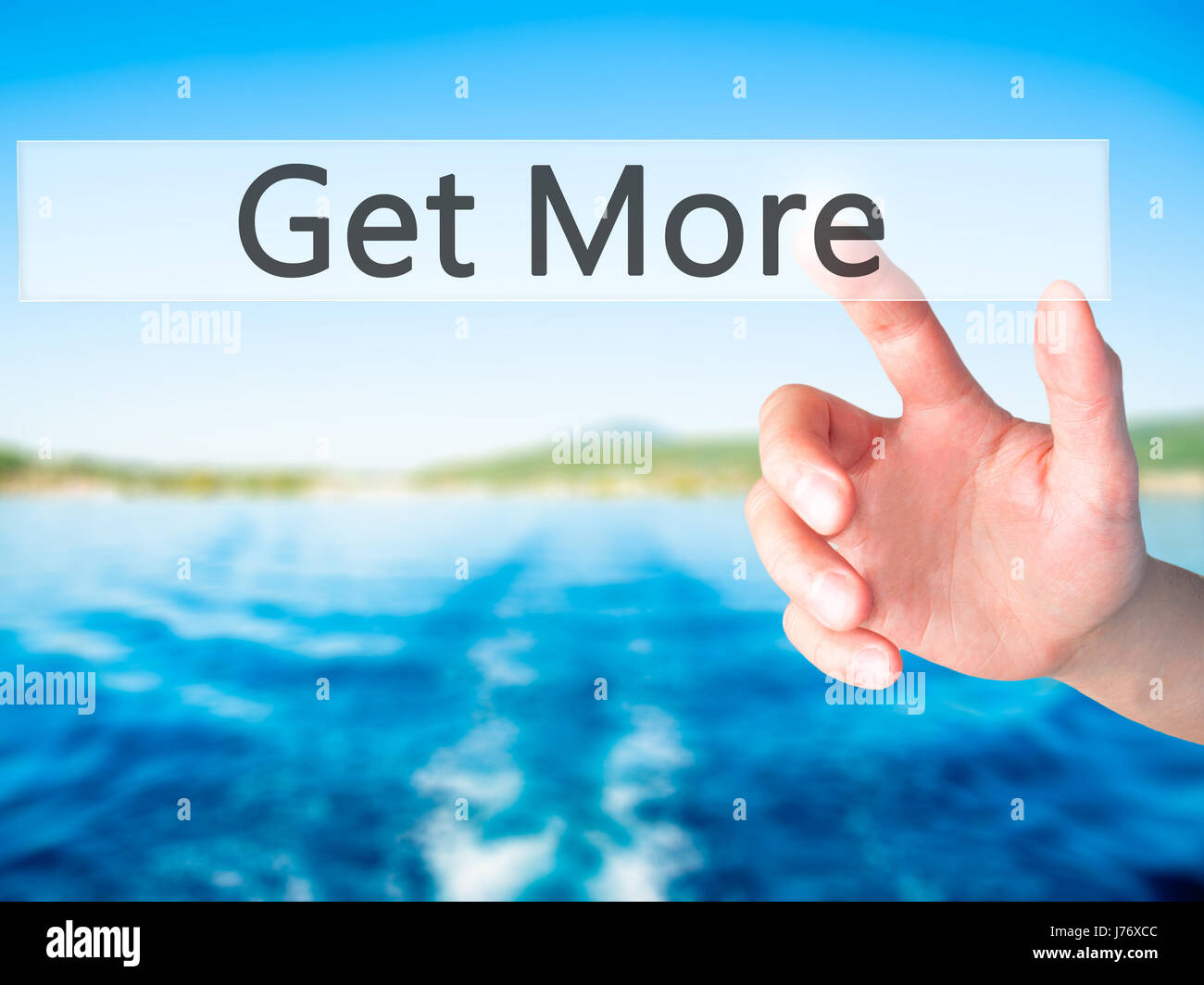 Get More - Hand pressing a button on blurred background concept ...