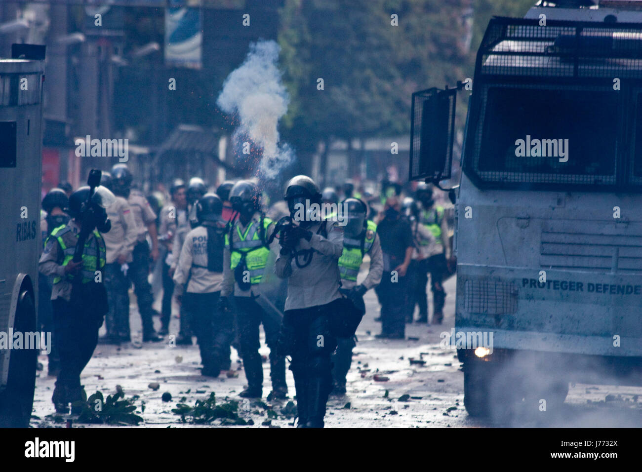 Police officers disperse a protest in Caracas. Stock Photo
