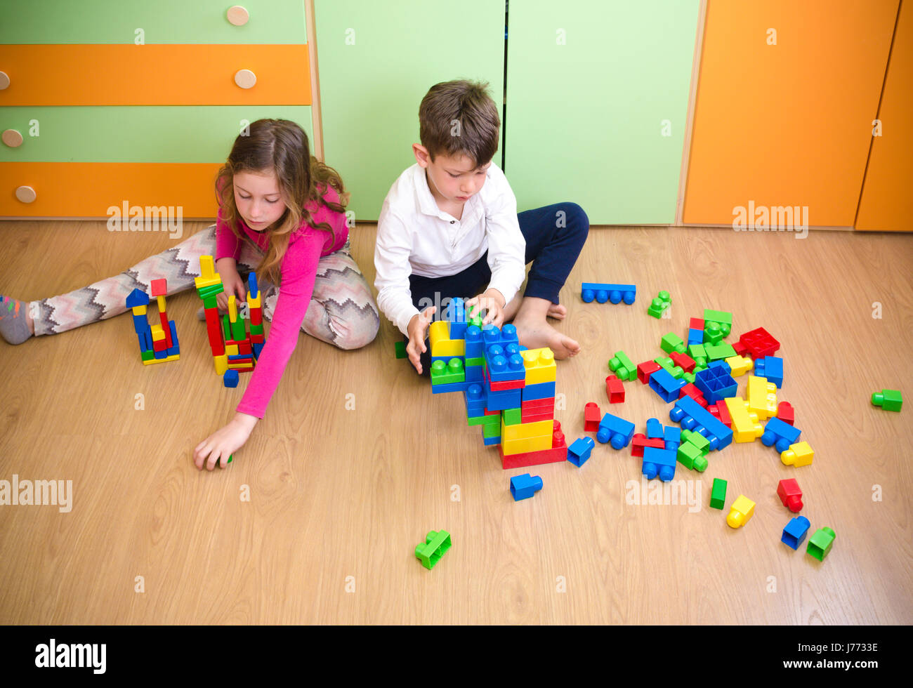 Children playing with construction toy blocks Stock Photo - Alamy