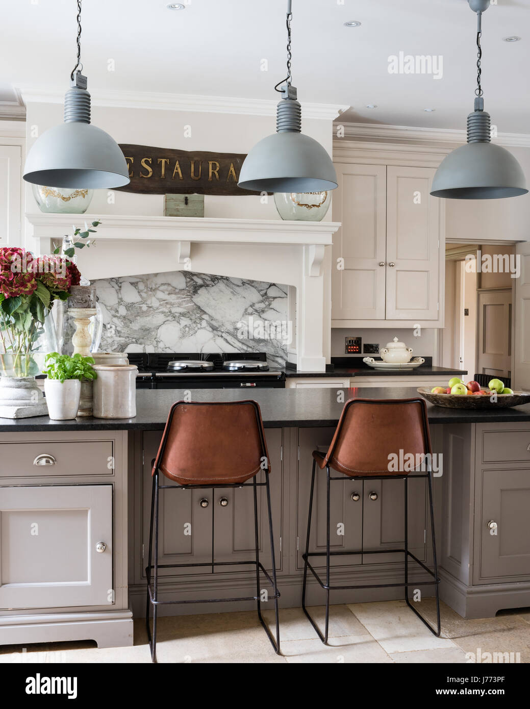 Pendant lights by Bardoe & Appela bove kitchen breakfast bar. The Sol y Luna bar stools are from Bardoe & Appel Stock Photo