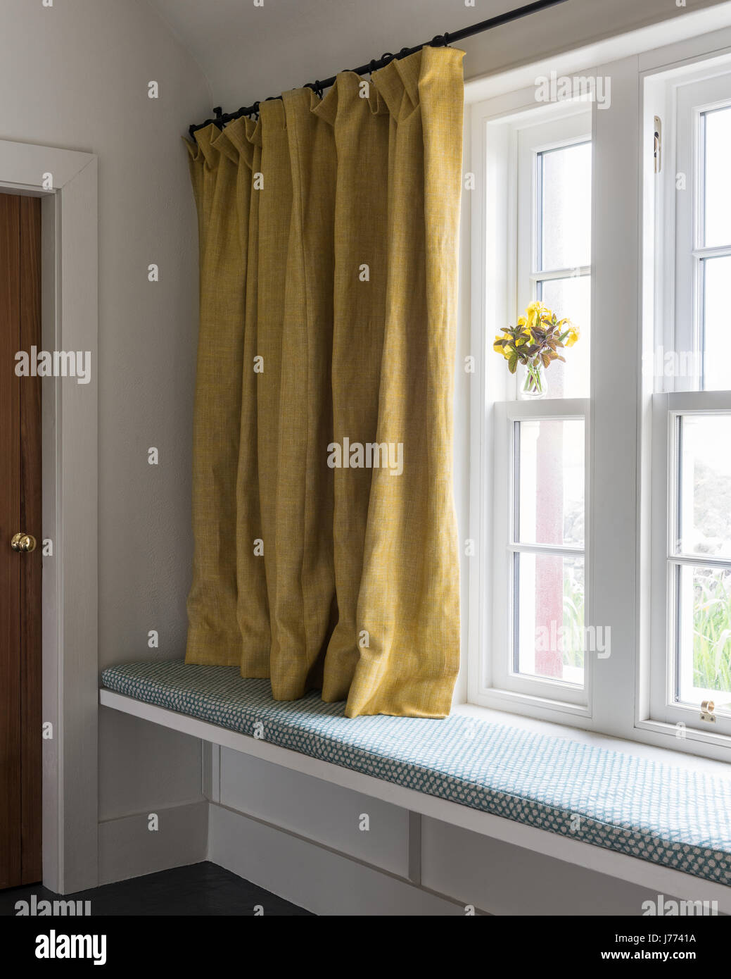 Linen curtains above window seat in 17th century stone cottage, Kintyre Stock Photo