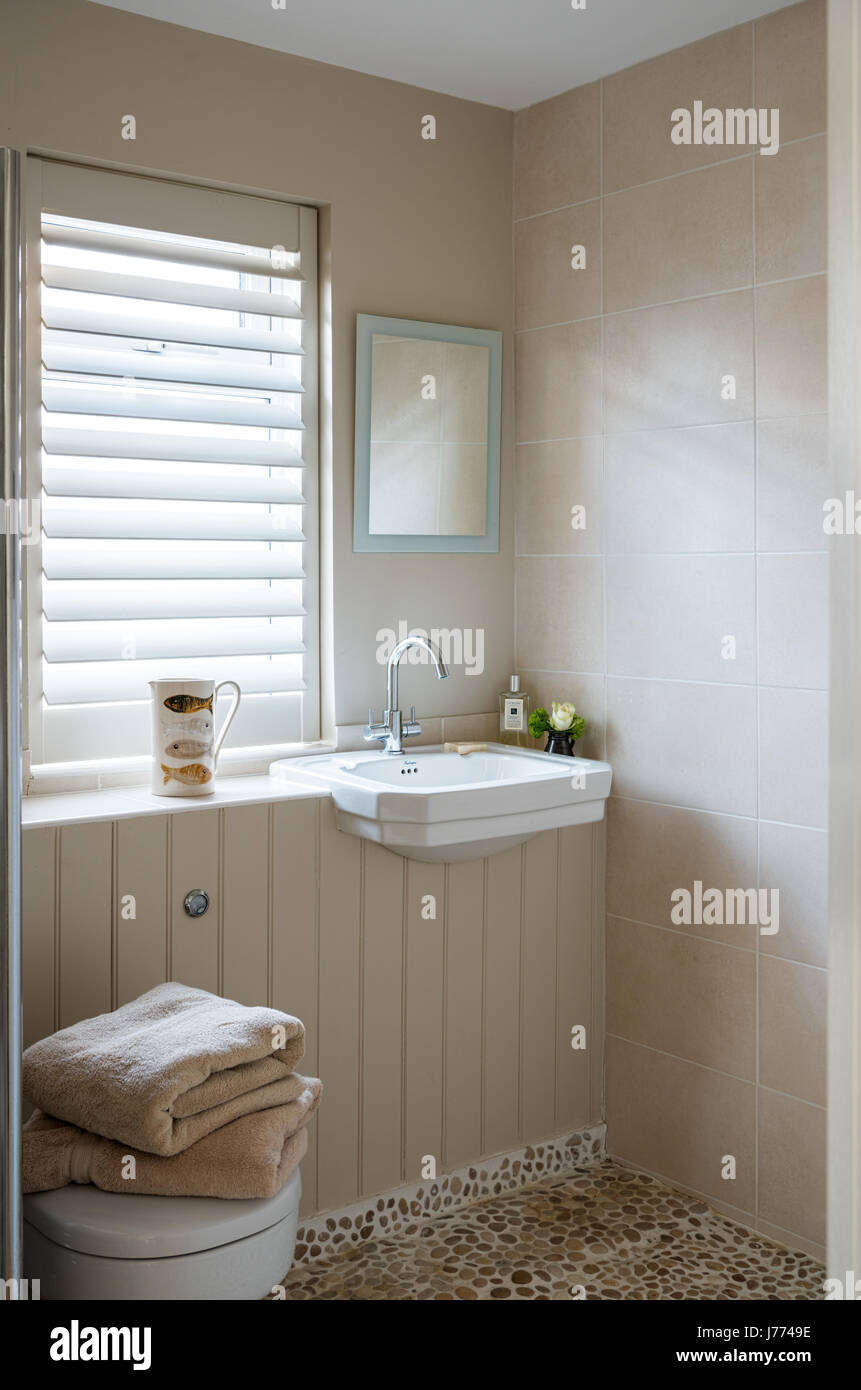 Pebble floor tiles from Marble Mosaics in en suite bathroom Stock Photo