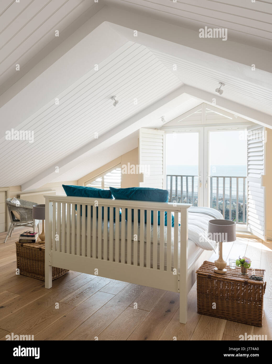 Feather & Black bed in top floor master bedroom with pitched ceiling