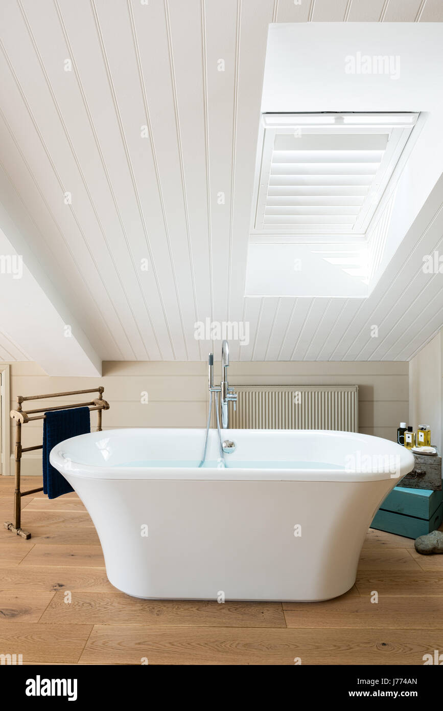Free standing bath in top floor master bedroom with pitched ceiling and