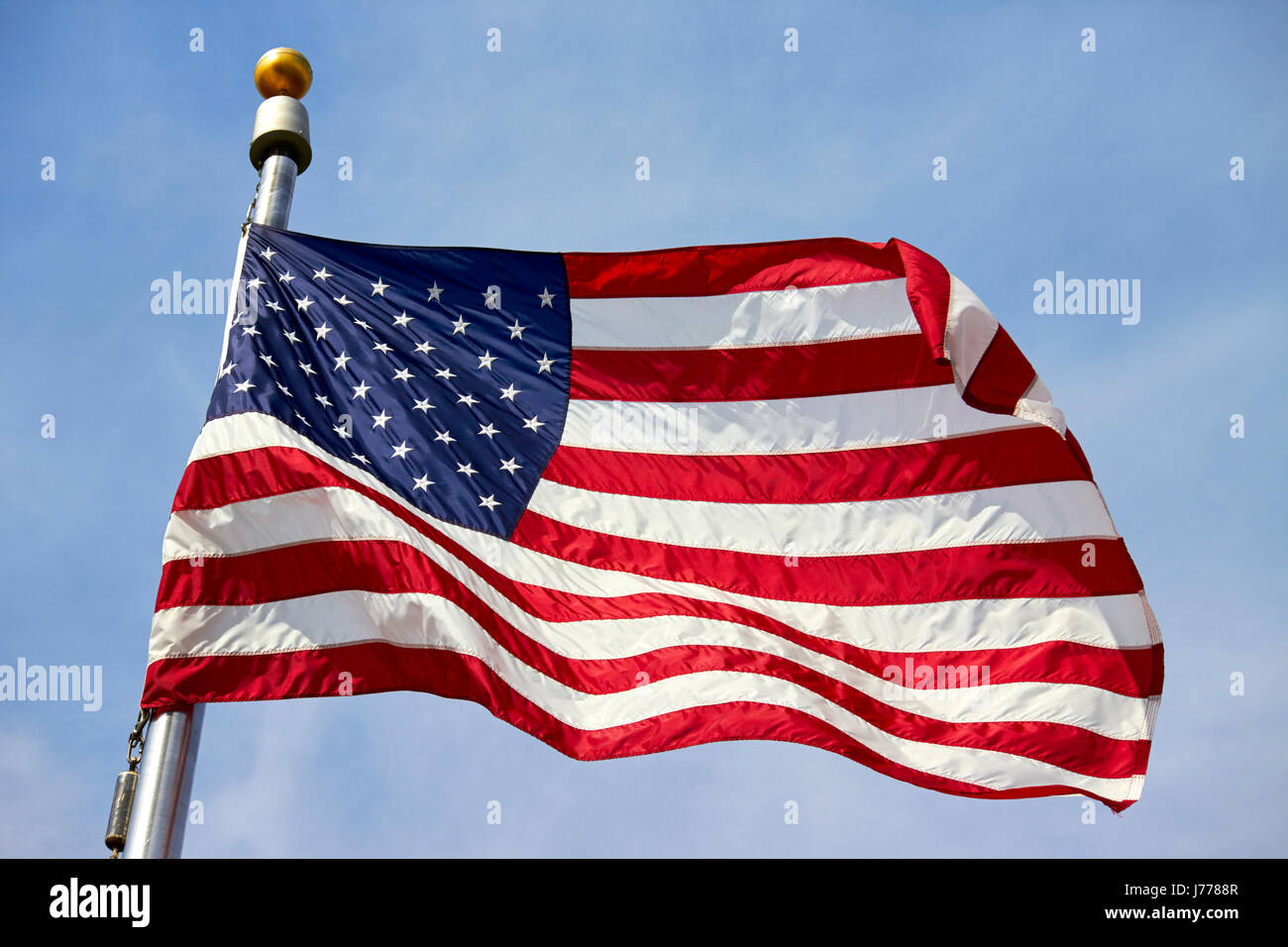 us flag flying against blue sky Washington DC USA Stock Photo