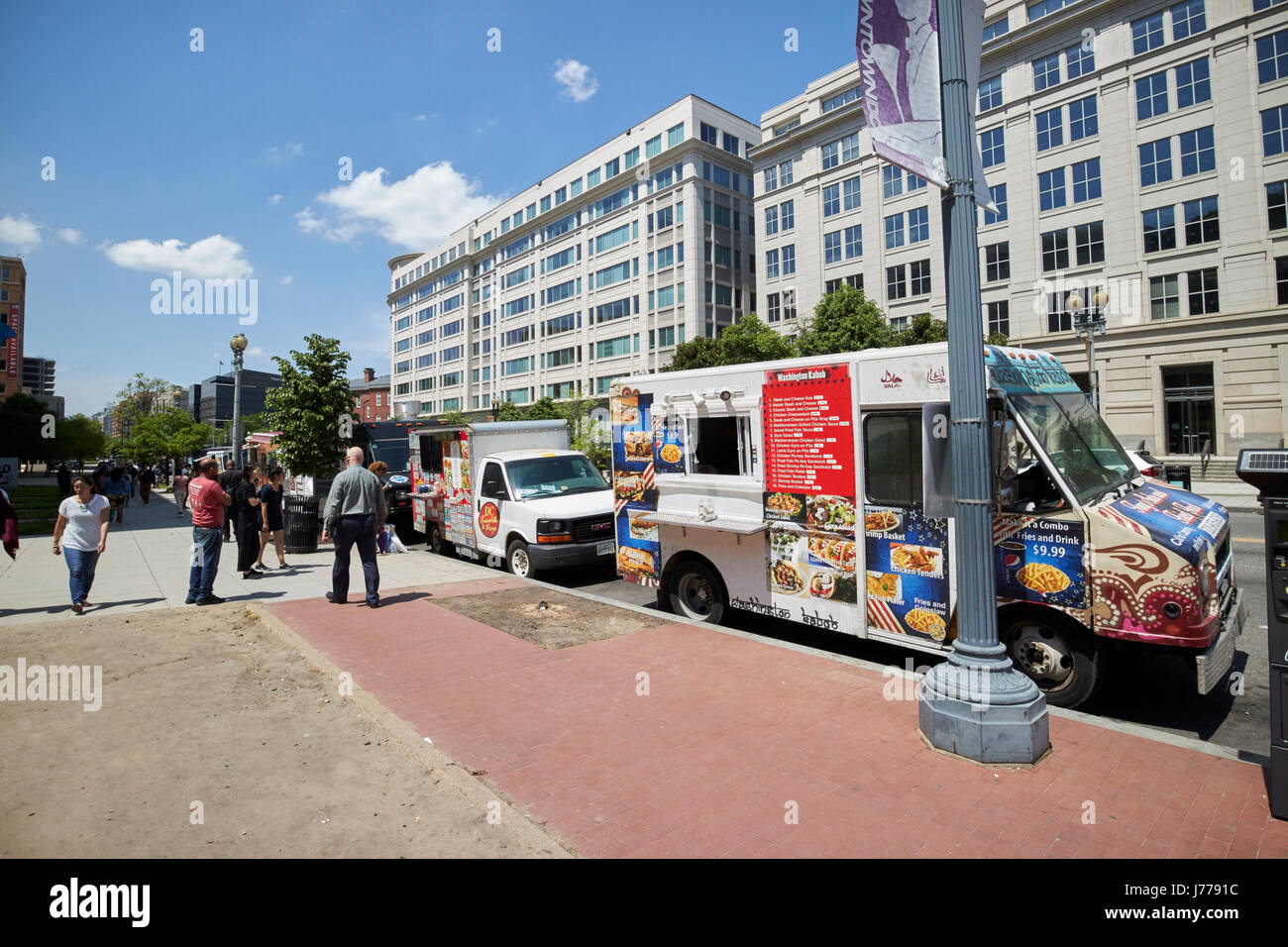 food trucks on massachusetts avenue nw in commercial district at lunchtime Washington DC USA Stock Photo