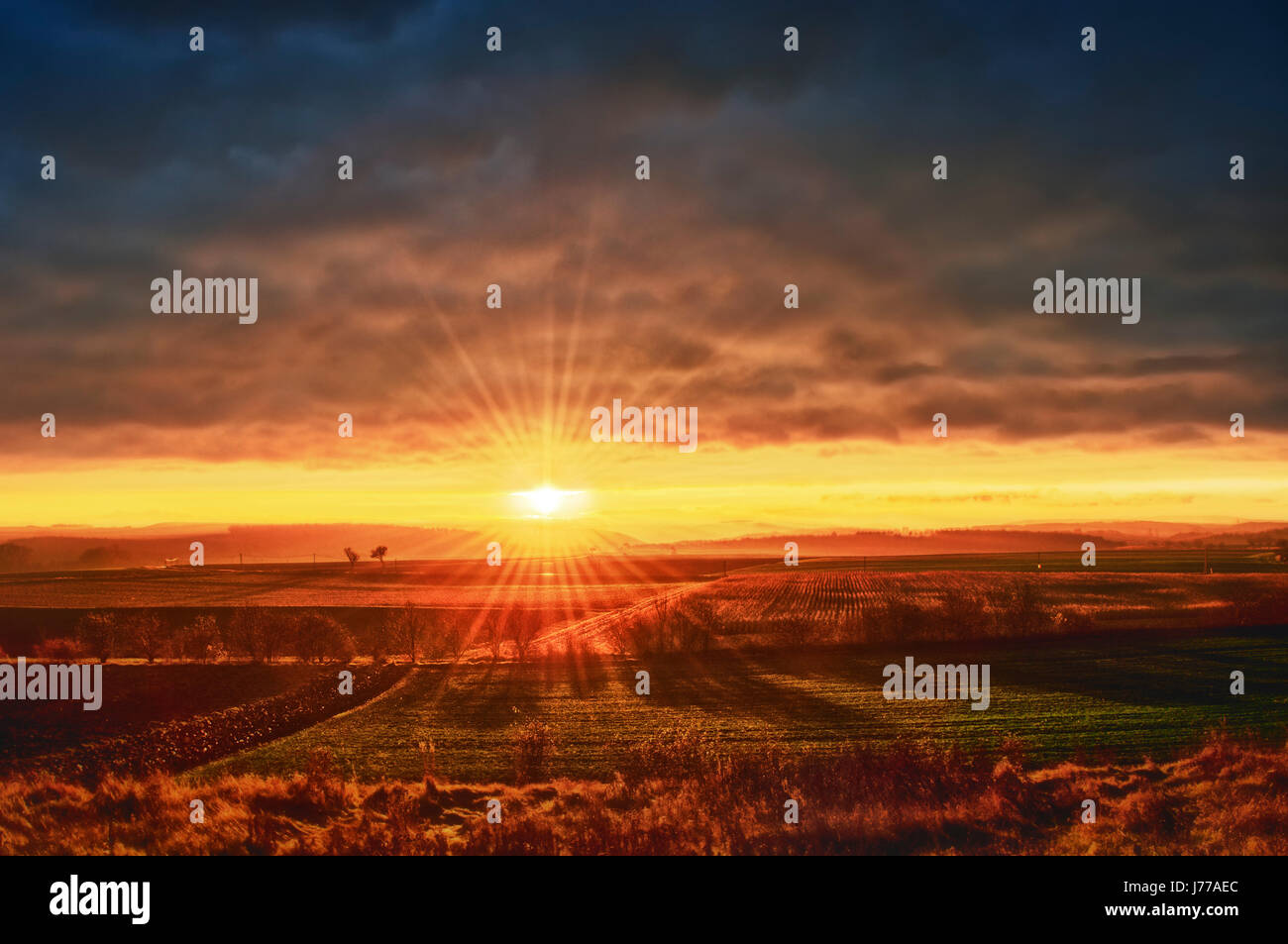sunset sunbeams fields firmament sky scenery countryside nature shine shines Stock Photo