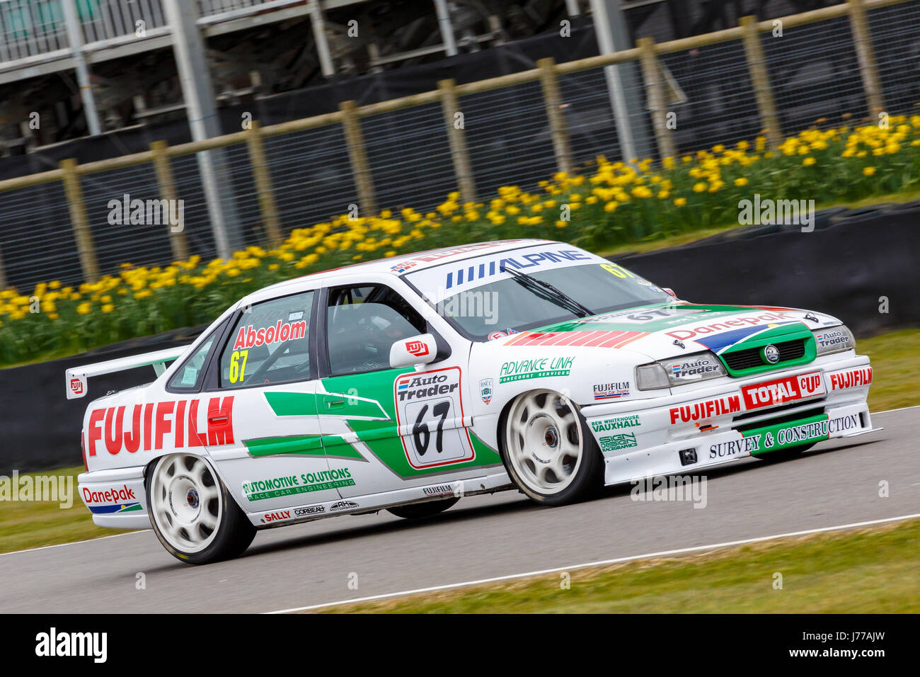 Tony Absolom's 1993 Vauxhall Cavalier GSI Super Touring Car with driver on a demonstration run at the Goodwood GRRC 74th Members Meeting, Sussex, UK. Stock Photo