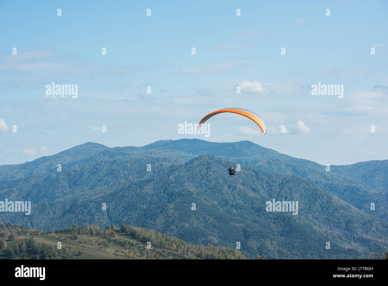 Paragliding in mountains Stock Photo