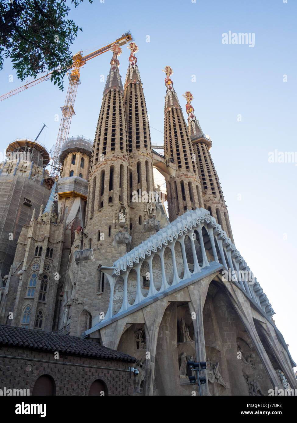 Elaborate sculptured spires and construction cranes and the Passion Façade of Gaudi's Sagrada Familia Basilica, Barcelona, Spain. Stock Photo