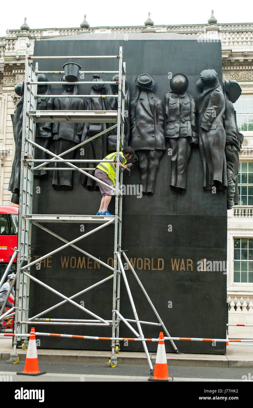 London, UK. 23rd May, 2017. 'Women of World War II' memorial in Whitehall sculpted by John W. Mills,  gets a spring clean as the Union Flag over Downing street flies at half-mast following the terrorist boming in Manchester at the Ariana Grande concert. Credit: JOHNNY ARMSTEAD/Alamy Live News Stock Photo
