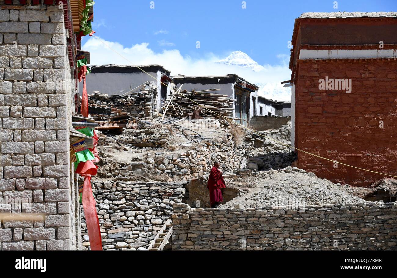 (170524) -- LHASA, May 24, 2017 (Xinhua) -- Lama Ngawang Peljor walks to his dormitory at the Rongpu Monastery near Mount Qomolangma in southwest China's Tibet Autonomous Region, May 17, 2017. Rongpu Monastery, the world's highest monastery at the altitude of over 5,000 meters, located at the foot of Mount Qomolangma in Tingri County. The 36-year-old Ngawang Peljor has practiced Buddhism in the monastery for 15 years. He lives a simple and regular monastic life here. Getting up at 8:30 a.m., he chants after breakfast till noon. He keeps chanting till 4 p.m. after one-hour break for lunch. Afte Stock Photo