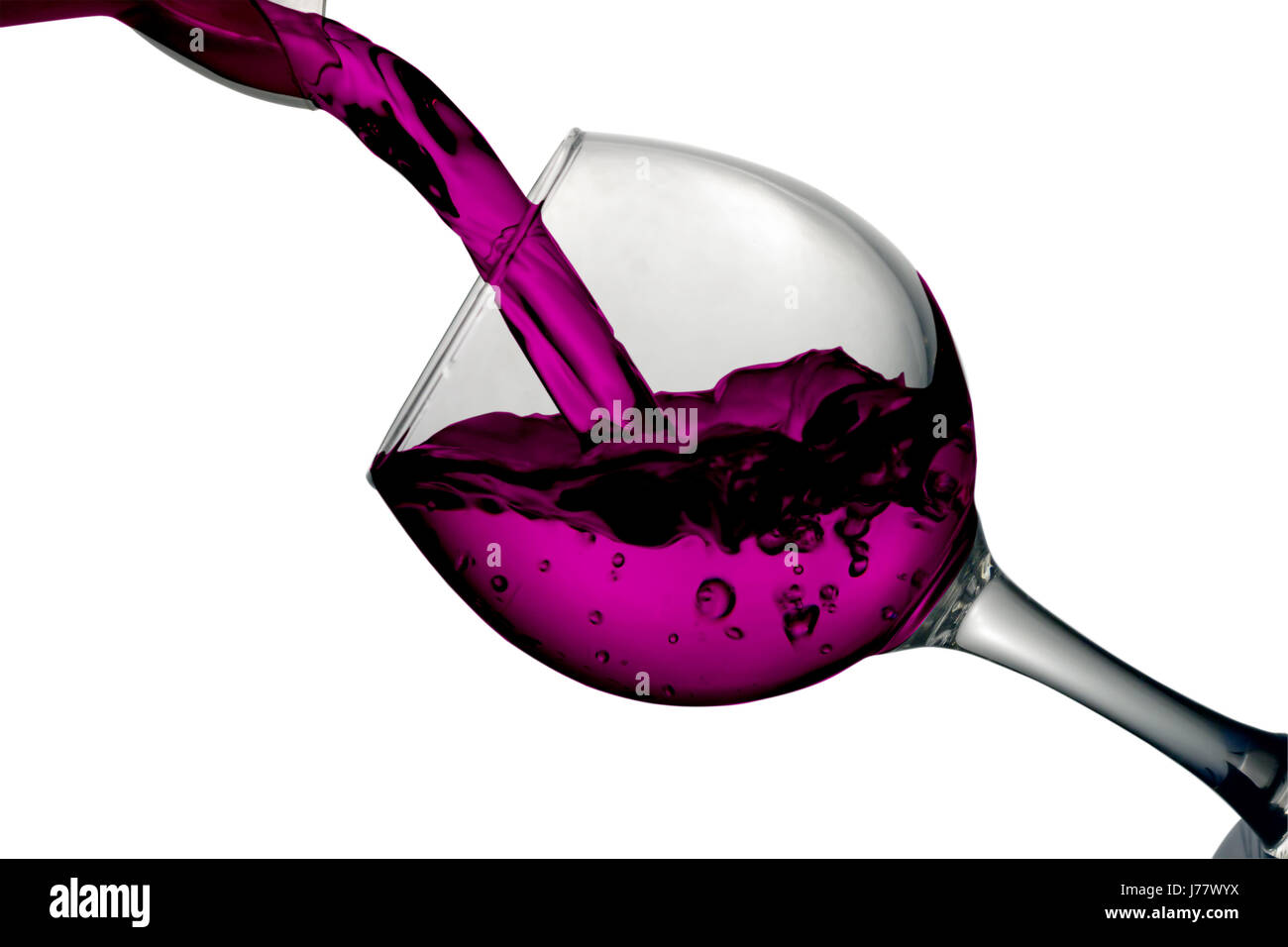 Red liquid, water, cherry juice, strawberry juice, red wine pouring into a glass, liquid in a speaker, isolated on a white background Stock Photo