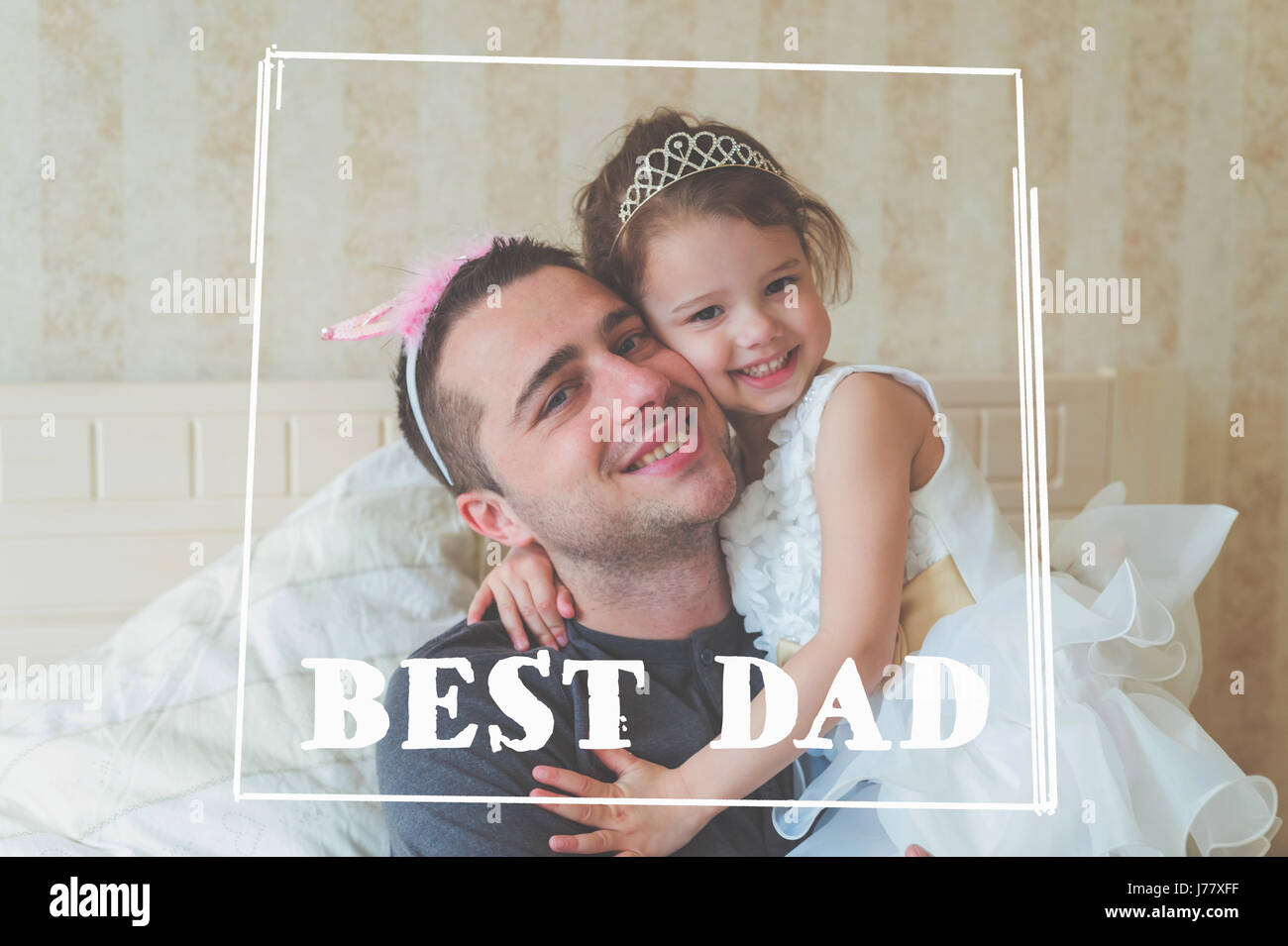 Little girl with father wearing crowns. Fathers day concept. Stock Photo