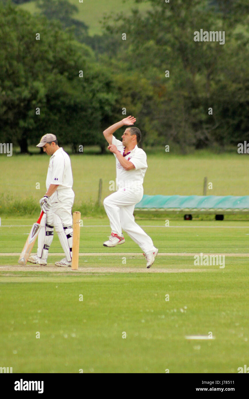 Bowling in an English game of cricket Stock Photo