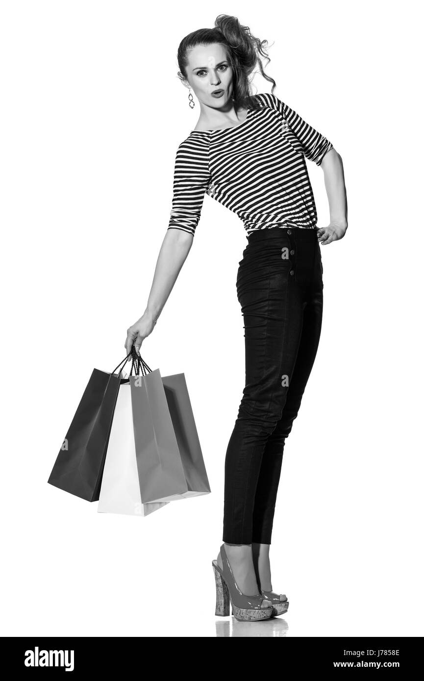 Shopping. The French way. Full length portrait of cheerful trendy woman with shopping bags of the colours of the French flag isolated on white backgro Stock Photo