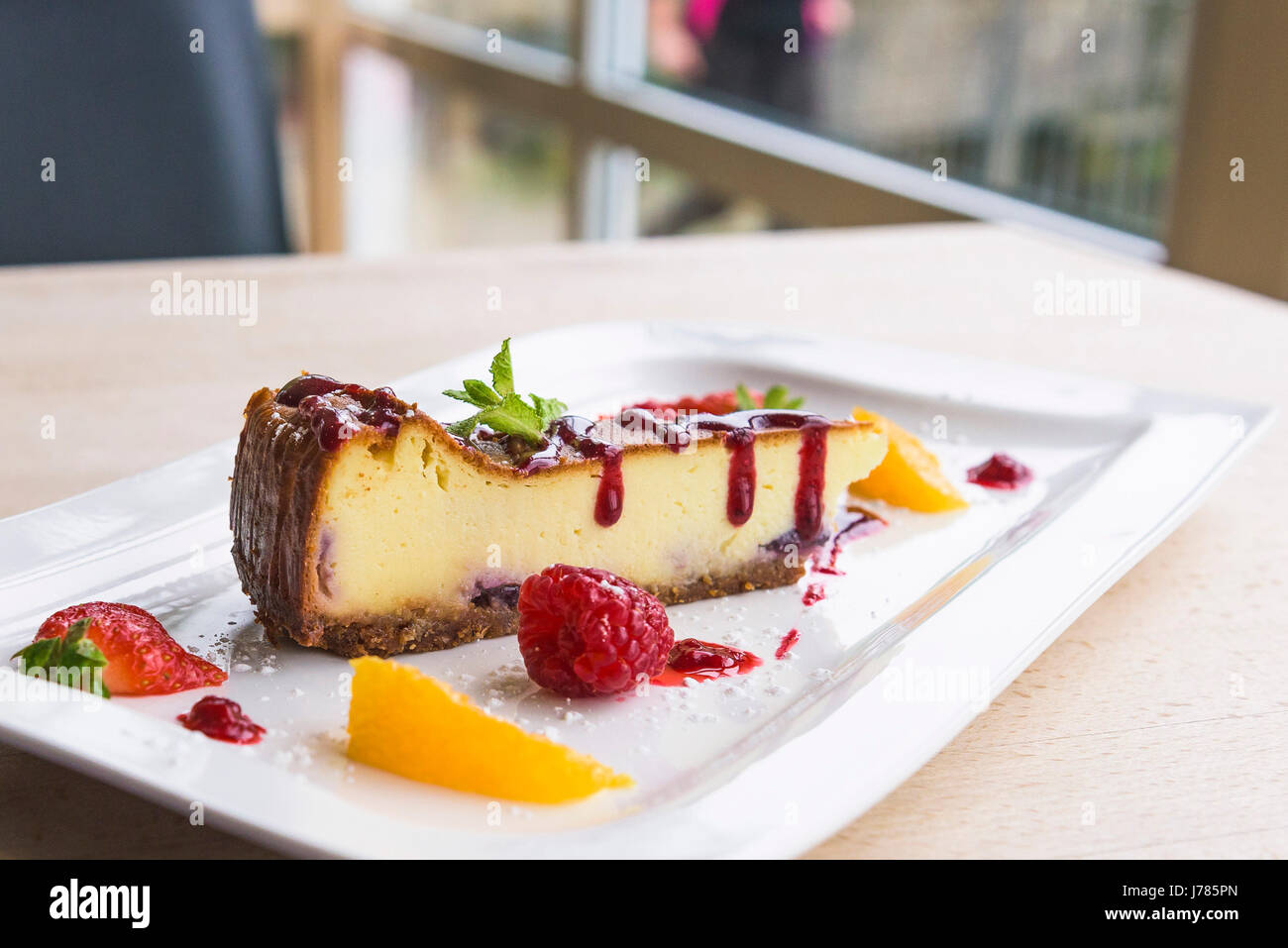 A closeup view of a colourful dessert served in a restaurant; Food; Sweet; Pudding; Cheesecake; Fruit; Tasty; Attractive presentation; Treat; Stock Photo