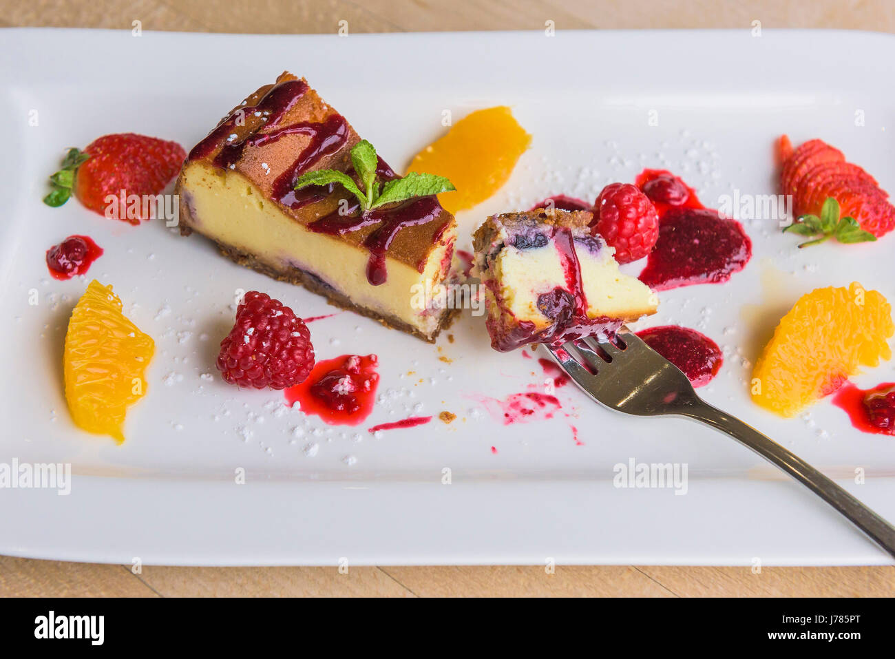 A closeup view of a colourful dessert served in a restaurant; Food; Sweet; Pudding; Cheesecake; Fruit; Tasty; Attractive presentation; Treat; Stock Photo