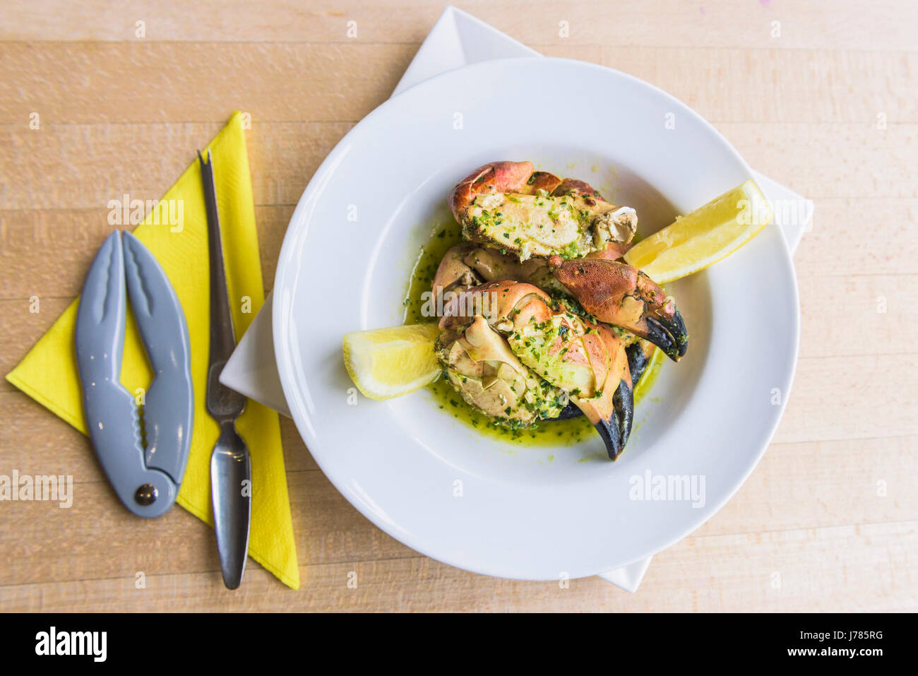A meal served in a restaurant; Crab; Crab claws; Sea food; Food; Serving; Portion; Restaurant interior; Dish; Appetising; Appetizing; Bowl; Cutlery; Stock Photo
