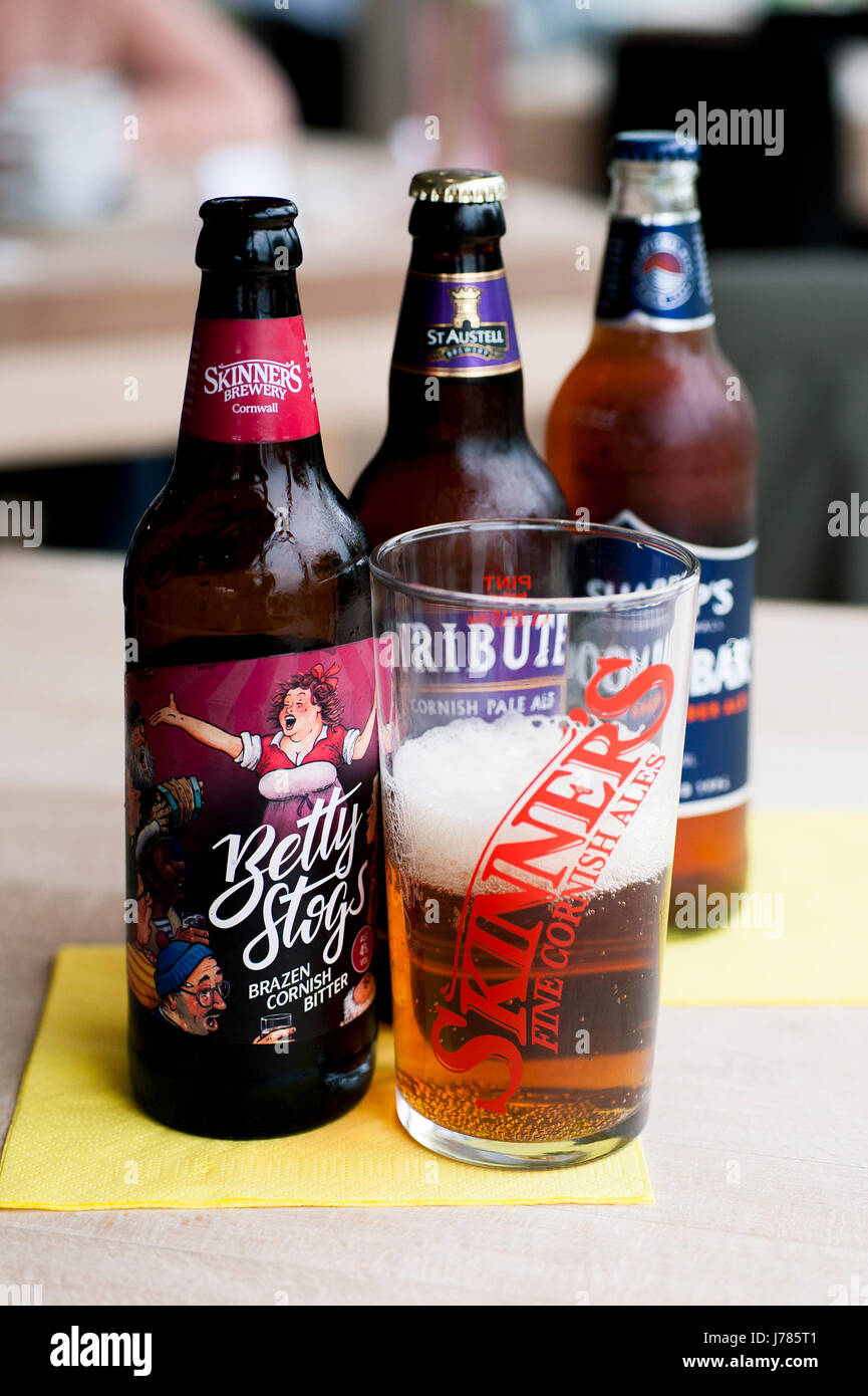 Bottles of beer and half filled pint glass. Stock Photo
