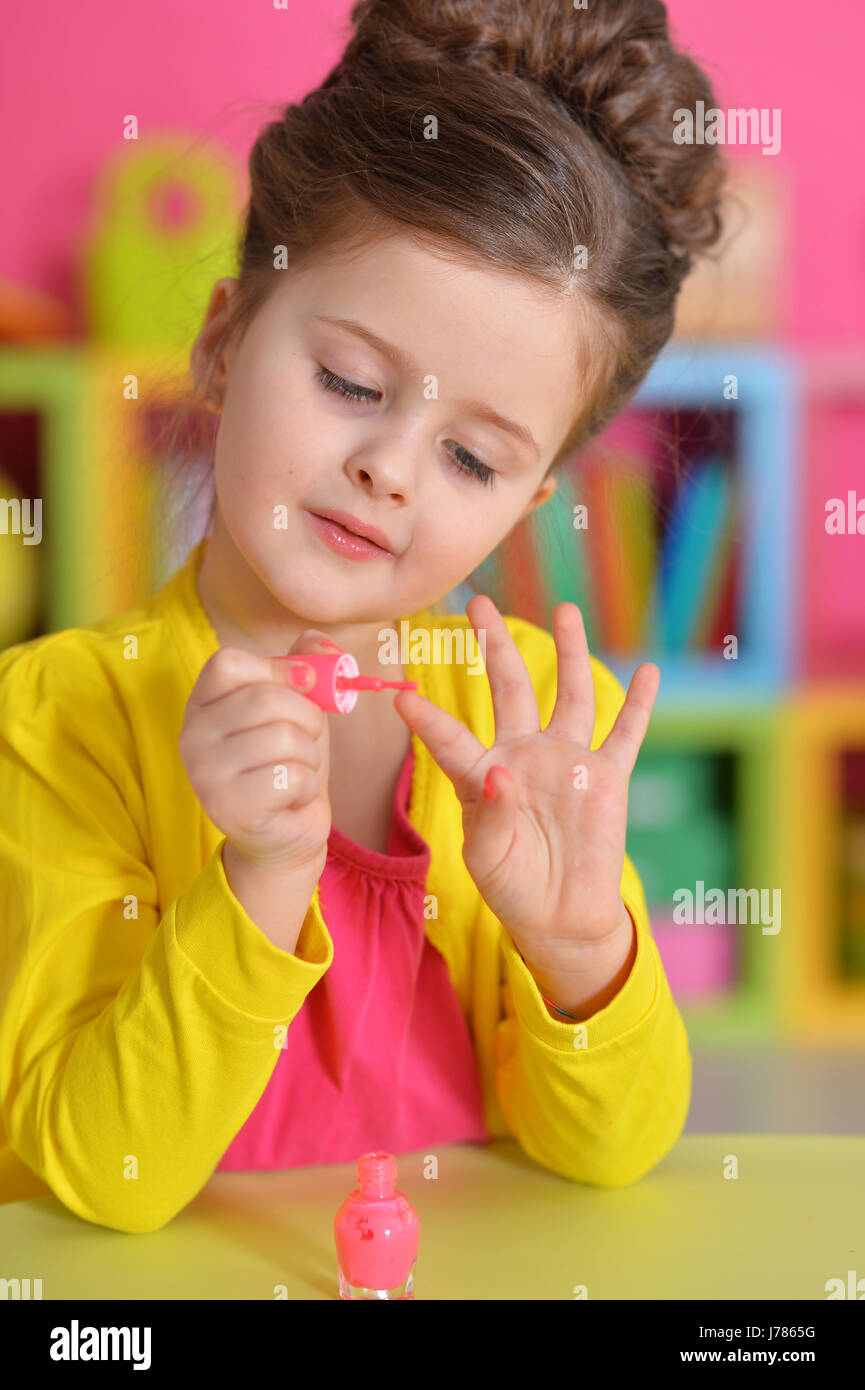 Portrait of a beautiful girl paints her nails Stock Photo Alamy