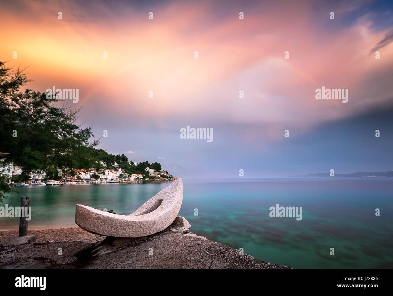 Rainbow over the White Stone Boat and Small Village in Omis Riviera, Dalmatia, Croatia Stock Photo