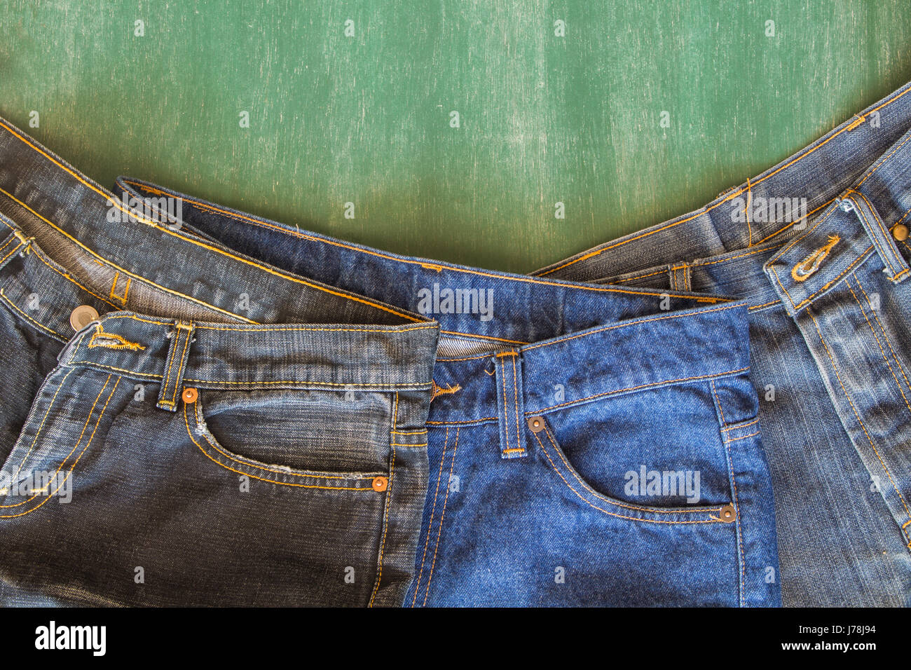 three of jeans with chalkboard background Stock Photo Alamy
