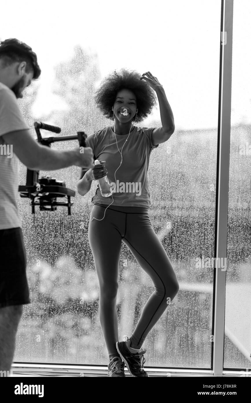portrait of young afro american woman in gym on work out break while teaking breath and fresh water rainy day and bad weather outdooor Stock Photo