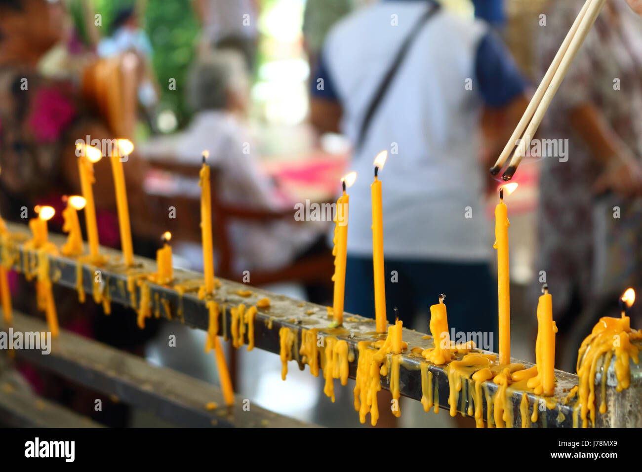 people lighing incense to pray from they faith in buddhism Stock Photo
