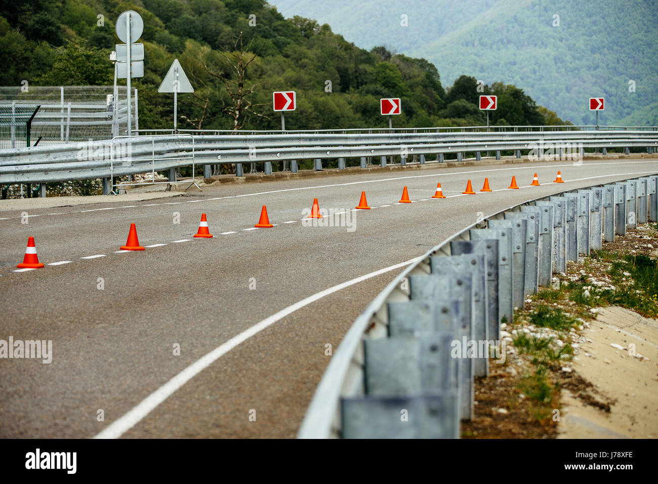 serpentine mountain roads with traffic cones safety and guardrail Stock Photo